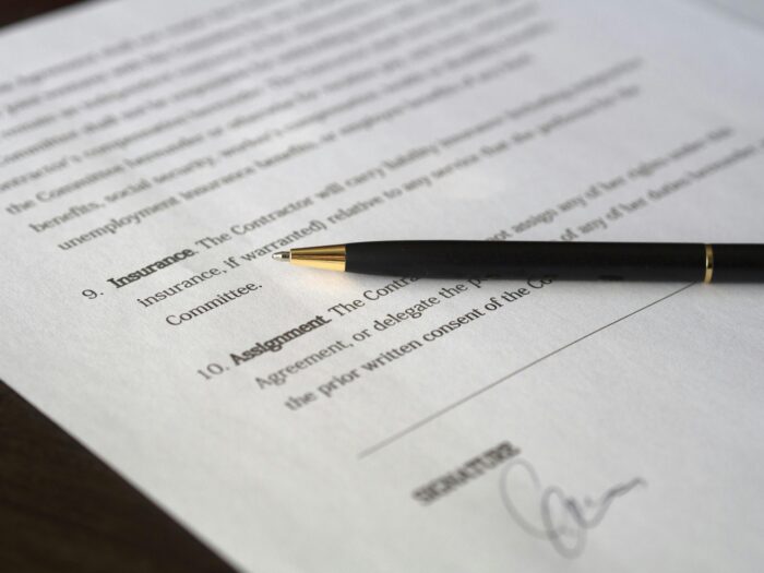 pexels-photo-261679-261679 Close-up image of a business contract and pen, signed and ready for agreement.